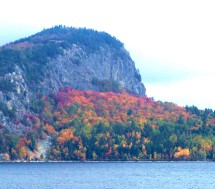Magnificent view of Mount Kineo across Moosehead Lake in Maine showing bright fall foliage colors